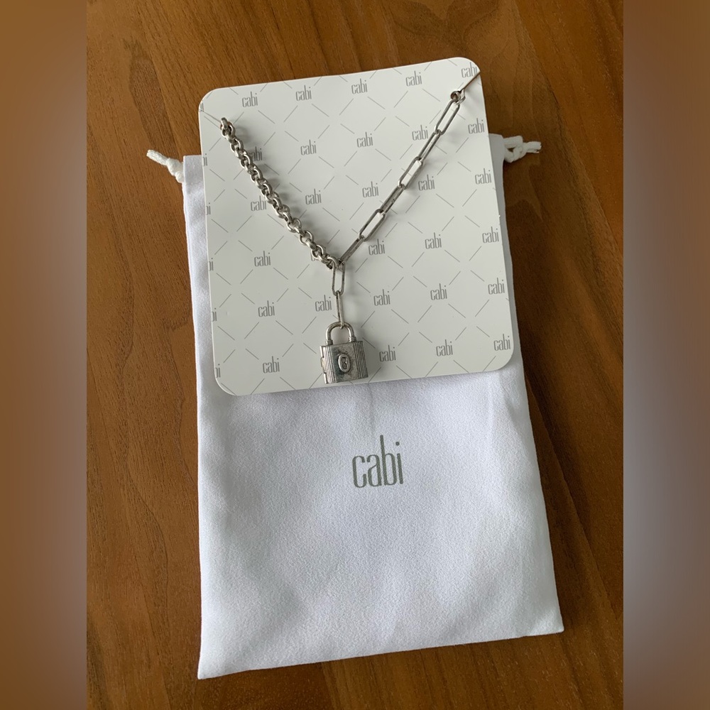 Cabi silvertone lock necklace. Matching earrings available. Cloth bag. NEW!